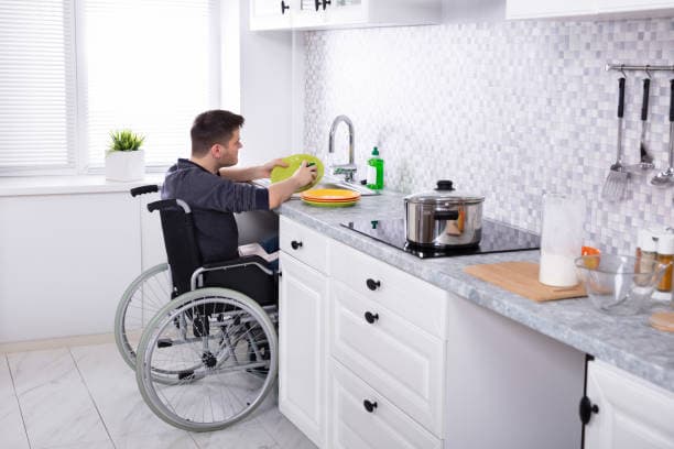 Participant washing dishes in the kitchen