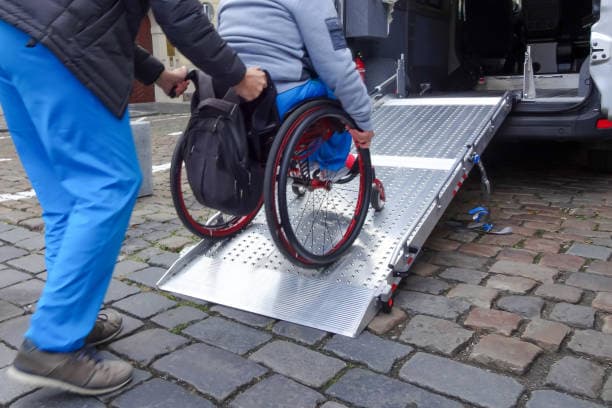 Support worker assisting a participant with accessible transport